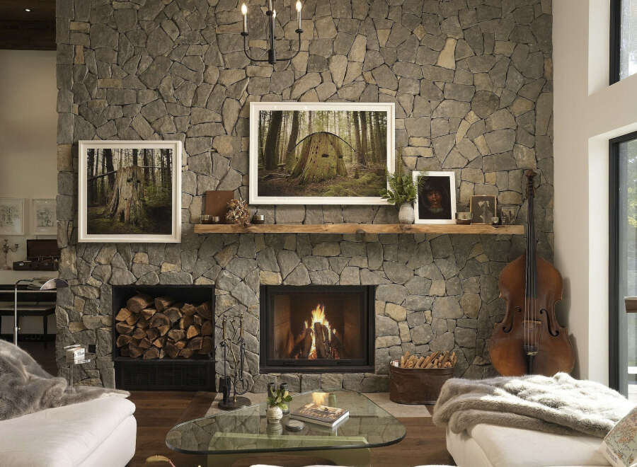 Experience rustic elegance in this stunning living room, featuring a grand stone fireplace as the centerpiece.