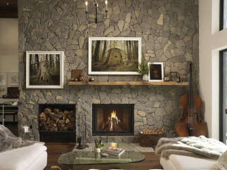 Experience rustic elegance in this stunning living room, featuring a grand stone fireplace as the centerpiece.
