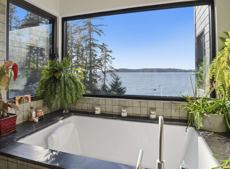 Indulge in ultimate relaxation with this stunning bathroom featuring a luxurious soaking tub.