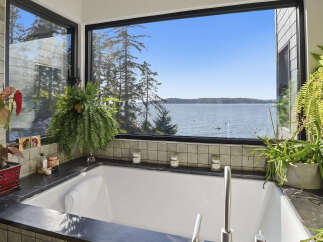 Indulge in ultimate relaxation with this stunning bathroom featuring a luxurious soaking tub.