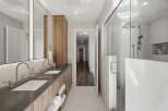 Experience luxury in this modern bathroom featuring a spacious double vanity with sleek faucets and ample storage.