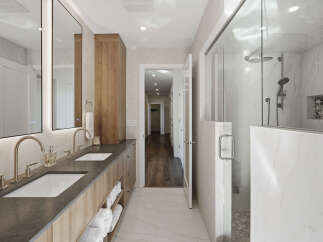 Experience luxury in this modern bathroom featuring a spacious double vanity with sleek faucets and ample storage.