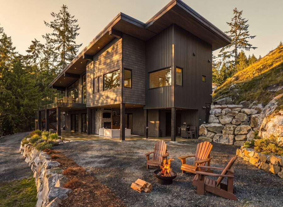Experience modern luxury in this stunning contemporary home nestled amidst a serene forest landscape.