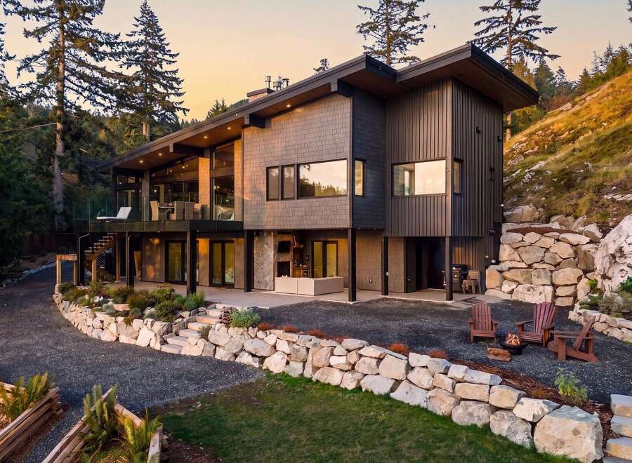 Experience modern luxury in this stunning hillside home, featuring expansive windows and a multi-level design that maximizes natural light and scenic views.