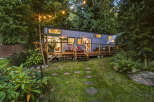Experience the charm of this modern tiny home nestled amidst lush greenery.