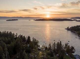 Experience breathtaking sunset views over the tranquil waters from this stunning coastal property.