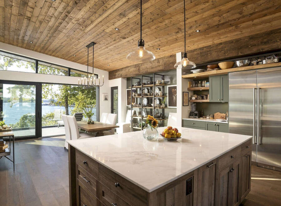 Experience luxury lakeside living in this stunning modern kitchen, featuring a large marble island perfect for entertaining.