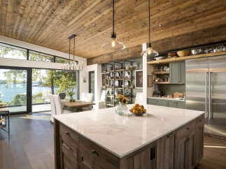Experience luxury lakeside living in this stunning modern kitchen, featuring a large marble island perfect for entertaining.