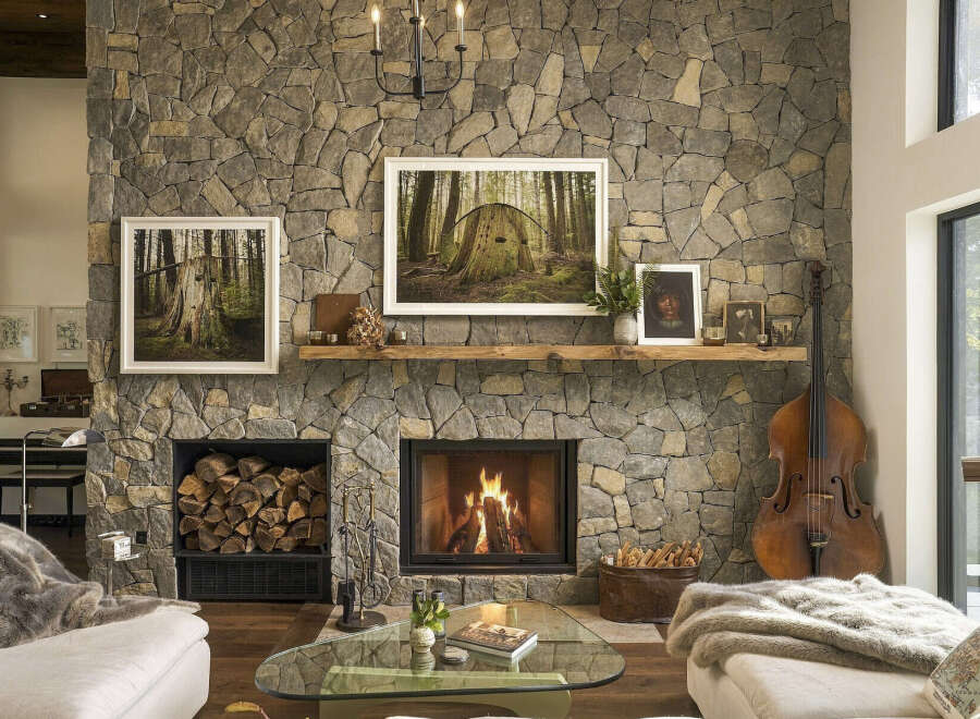 Experience rustic elegance in this stunning living room, featuring a grand stone fireplace as the centerpiece.