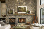 Experience rustic elegance in this stunning living room, featuring a grand stone fireplace as the centerpiece.