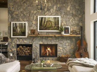 Experience rustic elegance in this stunning living room, featuring a grand stone fireplace as the centerpiece.