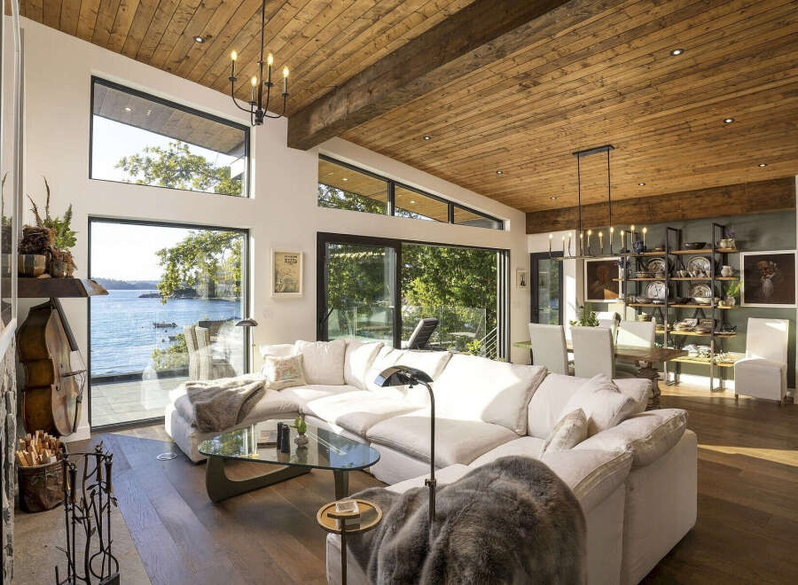 Experience breathtaking waterfront living in this stunning modern home, featuring expansive windows that flood the space with natural light and offer panoramic ocean views.