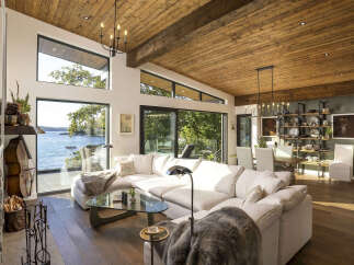 Experience breathtaking waterfront living in this stunning modern home, featuring expansive windows that flood the space with natural light and offer panoramic ocean views.