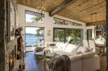 Experience breathtaking waterfront living in this stunning modern home, featuring expansive windows that flood the space with natural light and offer panoramic views of the serene lake.