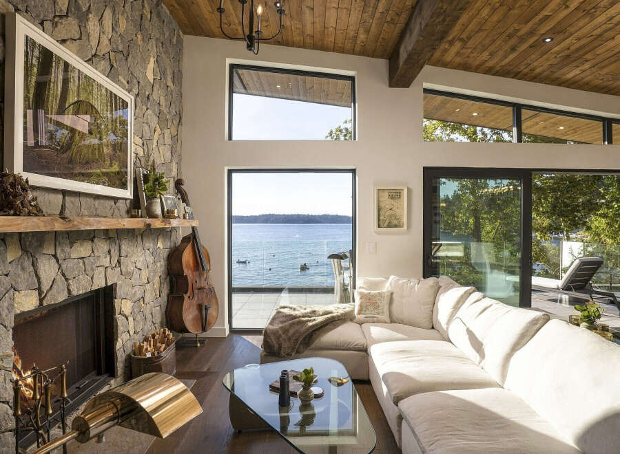 Experience breathtaking waterfront living in this stunning modern home, featuring expansive windows that showcase panoramic ocean views.