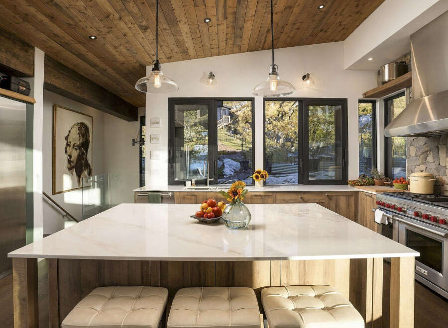 Experience luxury mountain living in this stunning kitchen, featuring a spacious marble island perfect for entertaining.