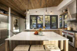Experience luxury mountain living in this stunning kitchen, featuring a spacious marble island perfect for entertaining.