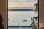 Experience breathtaking sunset views over the water from this stunning property.
