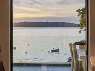 Experience breathtaking sunset views over the water from this stunning property.