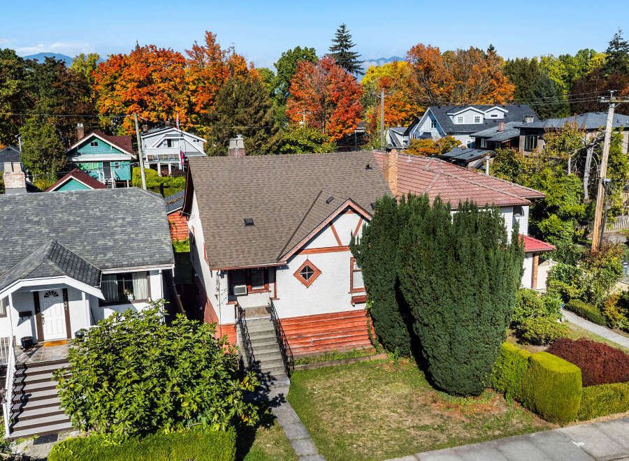 Discover this charming home nestled amidst vibrant autumn foliage, offering a picturesque setting with colorful trees.