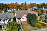 Discover this charming home nestled amidst vibrant autumn foliage, offering a picturesque setting with colorful trees.