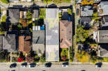 Discover this charming property from an aerial perspective, showcasing a well-maintained roof and a spacious backyard perfect for outdoor activities.