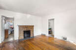 Step into this charming living space featuring a classic brick fireplace, perfect for cozy evenings.