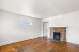 This charming living room features a classic brick fireplace, perfect for cozy evenings.