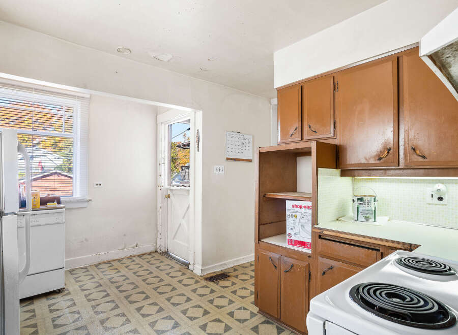 Discover this charming kitchen featuring a functional layout with ample cabinet space and a convenient dishwasher.