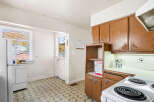 Discover this charming kitchen featuring a functional layout with ample cabinet space and a convenient dishwasher.