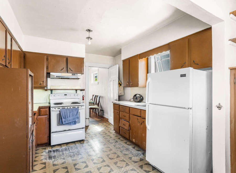 This kitchen features classic brown cabinetry offering ample storage space.