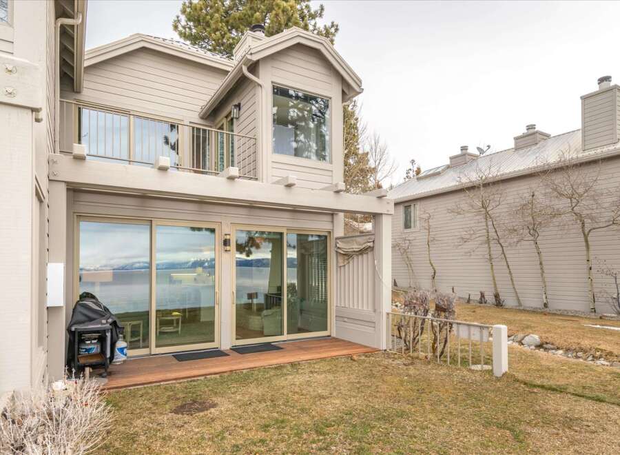 Experience breathtaking lake and mountain views from this stunning property, featuring expansive sliding glass doors that open onto a private deck.
