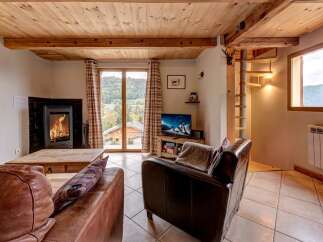 Experience cozy living in this charming mountain retreat, featuring a crackling fireplace and comfortable leather seating.