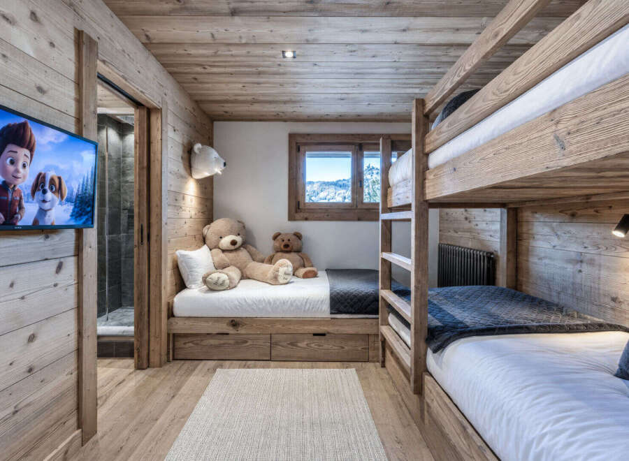 This charming children's room features a cozy bunk bed setup and a twin bed, perfect for sleepovers or family stays.