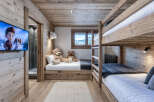 This charming children's room features a cozy bunk bed setup and a twin bed, perfect for sleepovers or family stays.