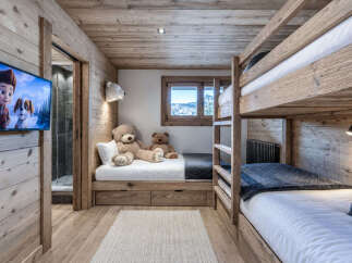 This charming children's room features a cozy bunk bed setup and a twin bed, perfect for sleepovers or family stays.