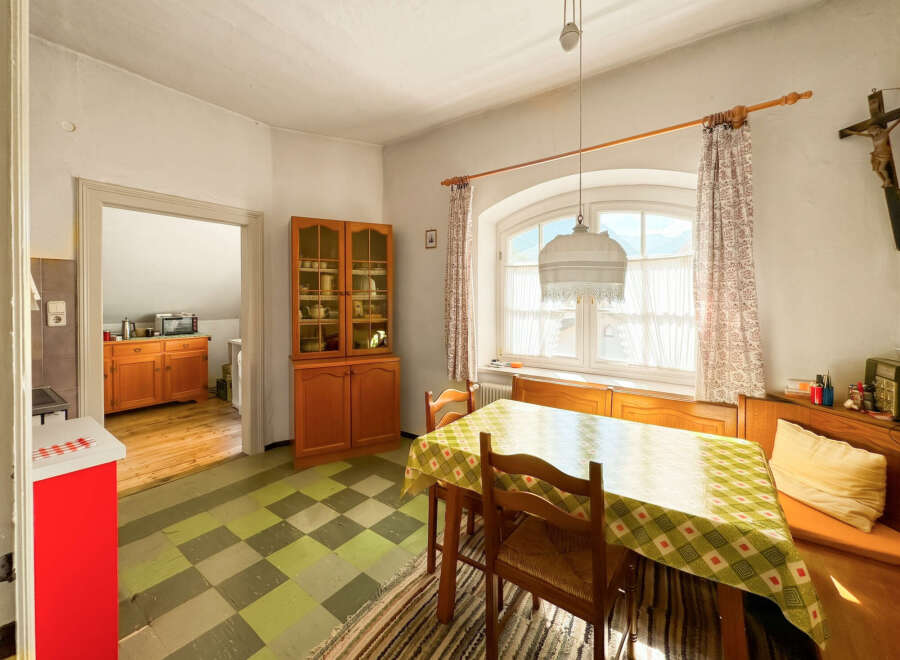 This charming dining area features a classic wooden hutch filled with dishes, perfect for displaying your fine china.