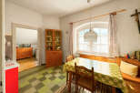 This charming dining area features a classic wooden hutch filled with dishes, perfect for displaying your fine china.