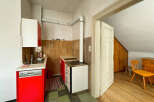 Discover this charming kitchen featuring vibrant red cabinets and a functional stovetop.