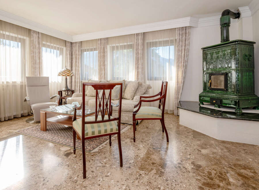 Experience luxurious living in this elegantly appointed living room, featuring a plush sofa, comfortable armchairs, and a stylish coffee table.