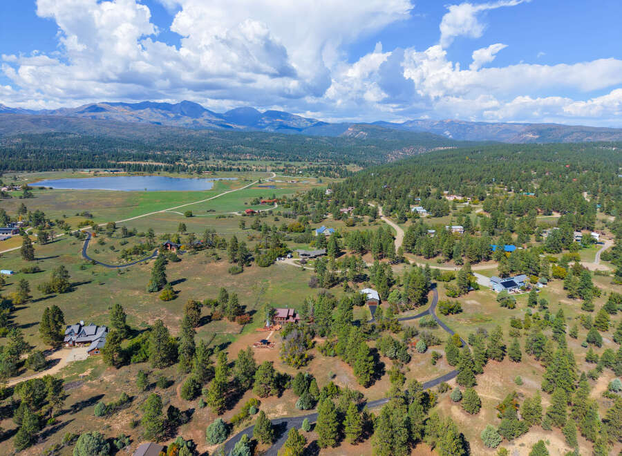 Discover this stunning property nestled amidst rolling hills and mature pine trees, offering breathtaking mountain views.