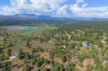 Discover this stunning property nestled amidst rolling hills and mature pine trees, offering breathtaking mountain views.