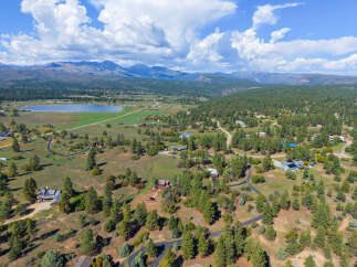 Discover this stunning property nestled amidst rolling hills and mature pine trees, offering breathtaking mountain views.