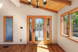Step into this inviting entryway featuring a stunning double door with intricate stained glass panels, flooding the space with natural light.