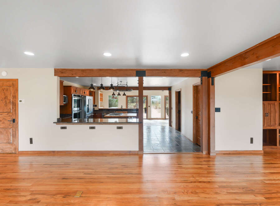 Step into this beautifully renovated home featuring a spacious open-concept living area with gleaming hardwood floors.