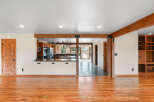 Step into this beautifully renovated home featuring a spacious open-concept living area with gleaming hardwood floors.