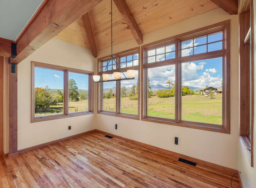 Experience breathtaking panoramic views from this sun-drenched room, featuring expansive windows that showcase the stunning natural landscape.
