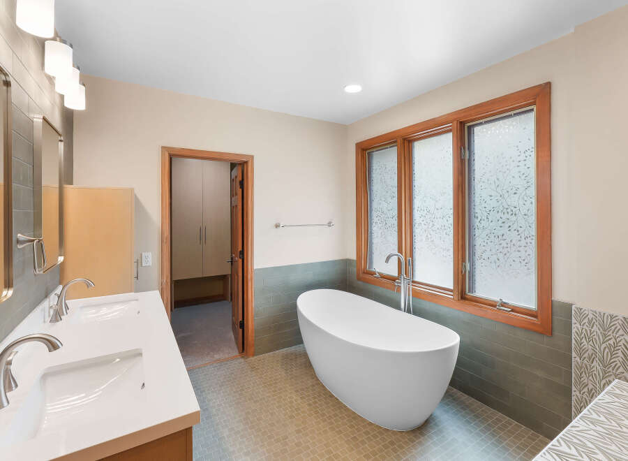 Indulge in luxury with this stunning bathroom featuring a freestanding soaking tub, perfect for unwinding after a long day.