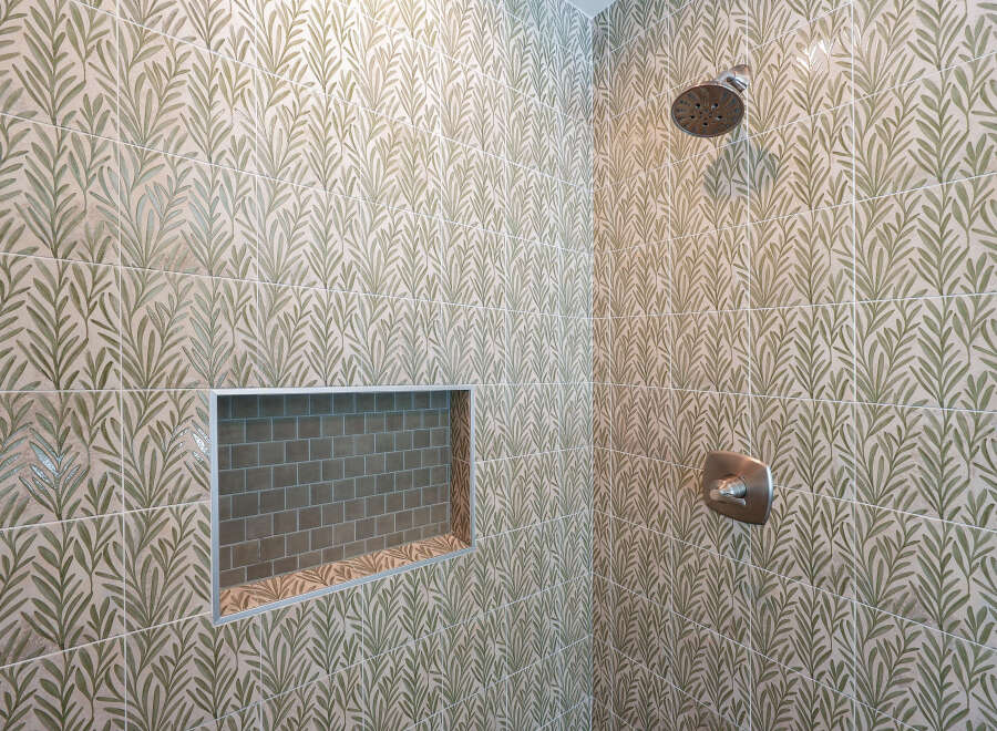 Step into a beautifully designed shower featuring elegant botanical-patterned tiles in a soothing green and beige palette.