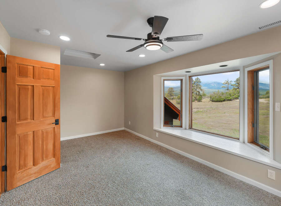 Step into this inviting room, featuring a warm wooden door and plush carpeting for a cozy feel.